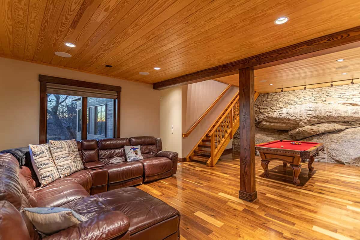 Lower level lounge with leather sectional and pool table