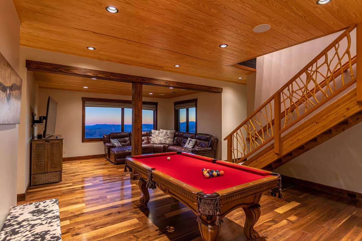 Game room with pool table and twig style stair railing