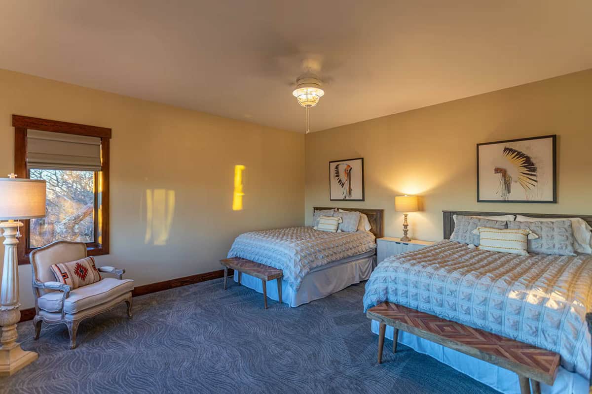 Guest bedroom with two beds and Native American themed art