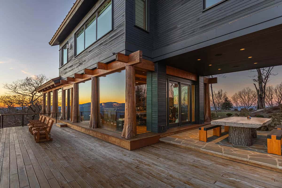 Covered patio with tree stump table and mountain sunset view