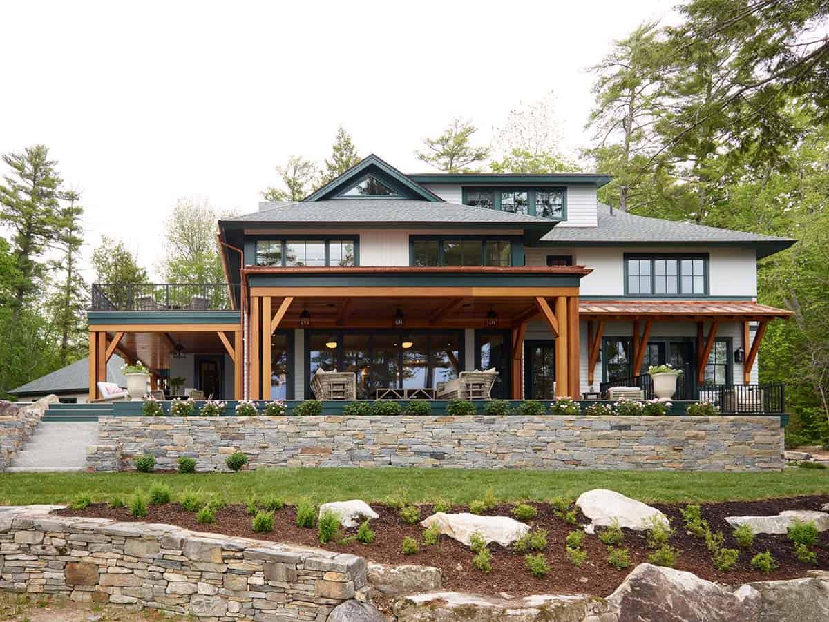 Back facade with copper roof accents, timber columns, and stacked stone wall