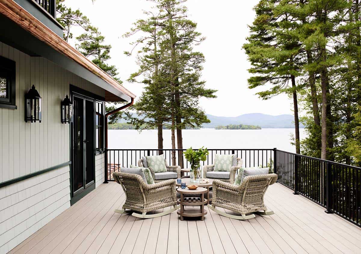 Upper deck with wicker rocking chairs and views of Lake Winnipesaukee