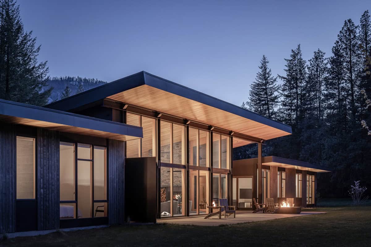Home exterior at dusk with glowing windows and covered porch