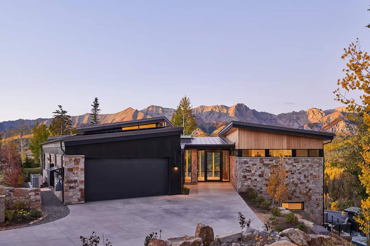 Front exterior with dark facade, stone base, and wood accents