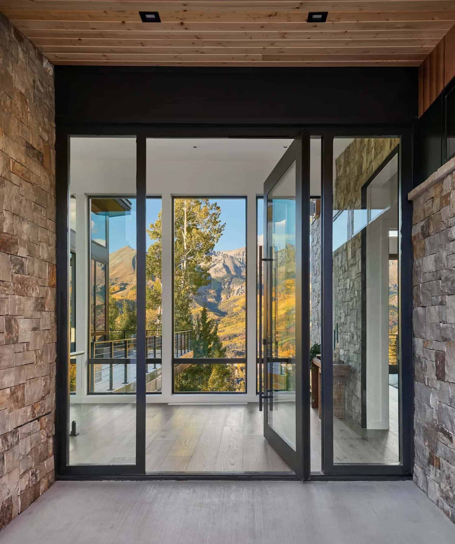 Pivot front door opening to a mountain and aspen view