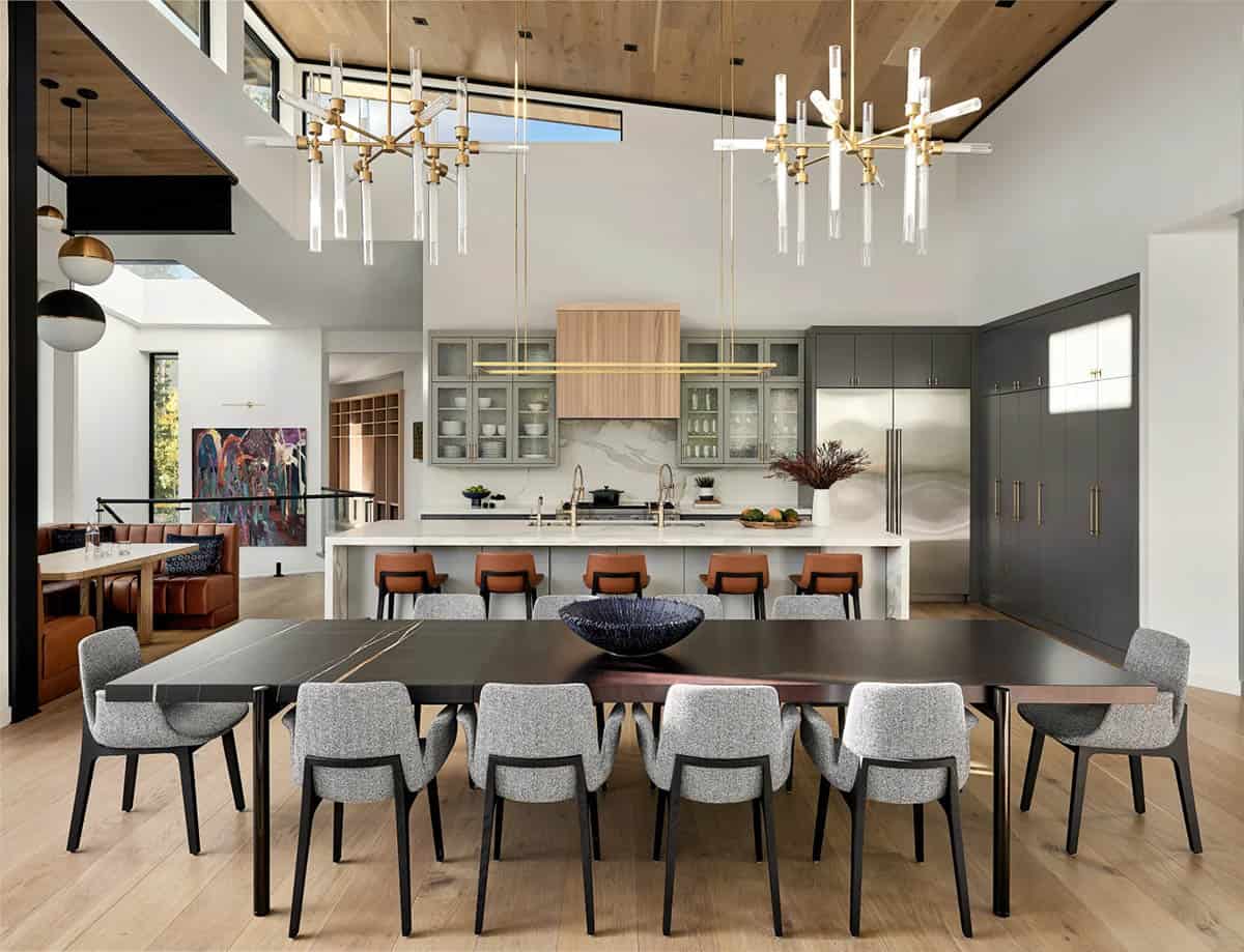 Kitchen island and dining table beneath sculptural glass chandeliers