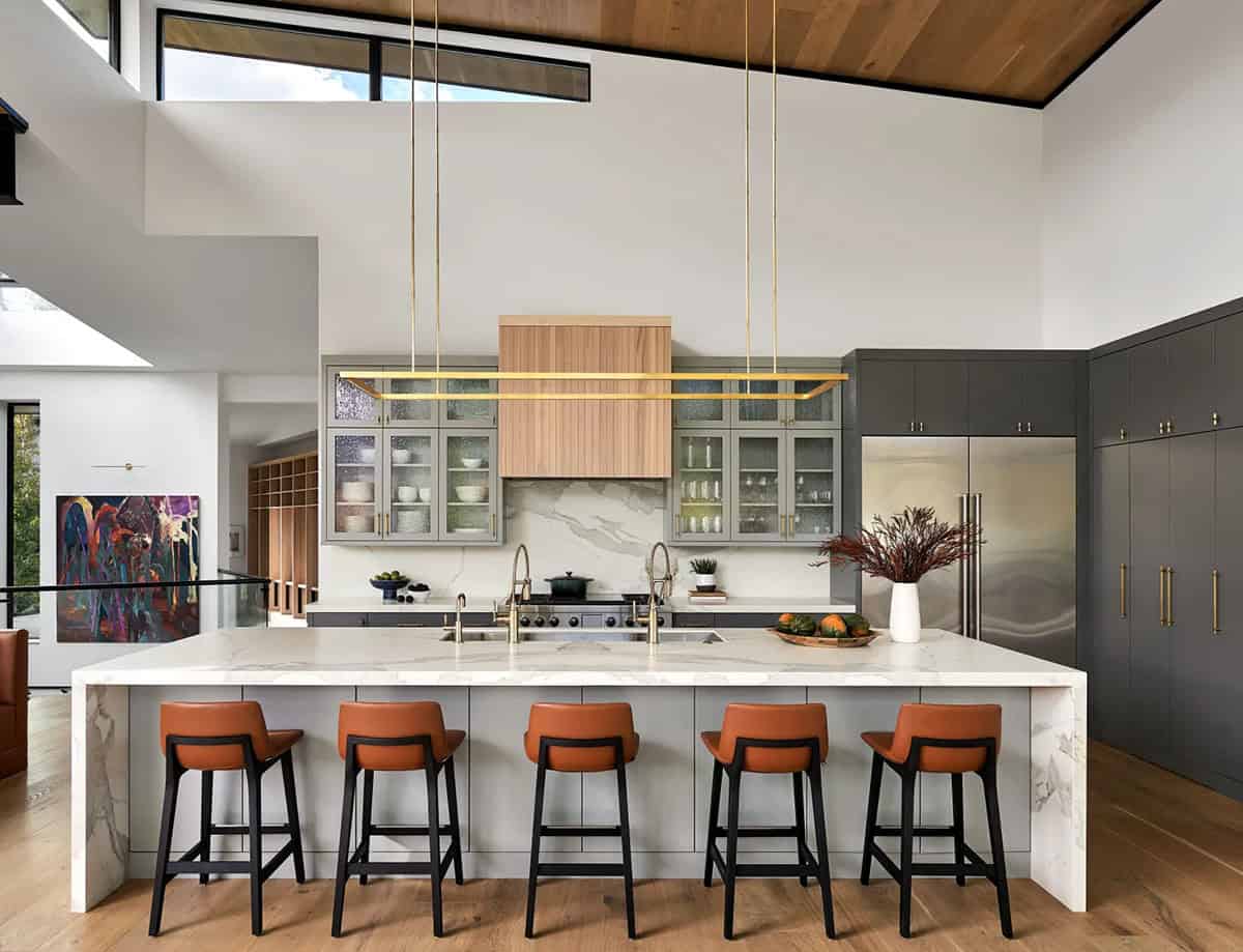 Kitchen island with marble counter and cognac leather barstools