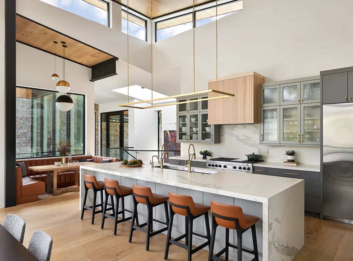 Kitchen with gray cabinetry and warm wood range hood
