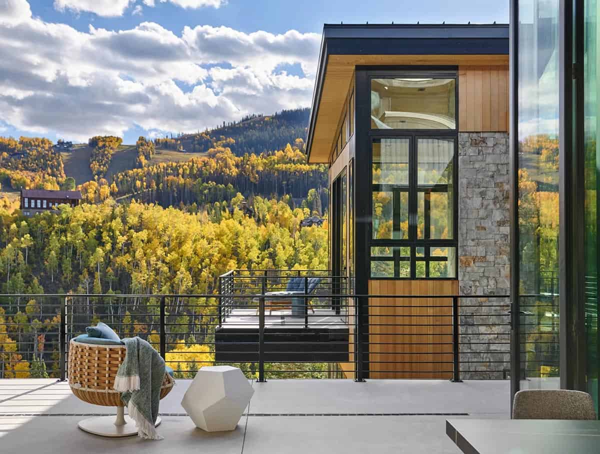 Upper deck with woven chair overlooking aspen covered hillside