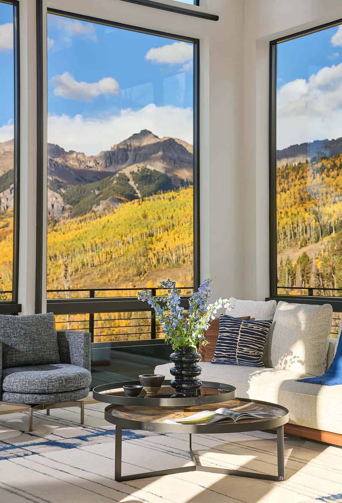 Sitting nook with wildflowers framed by peak and forest views