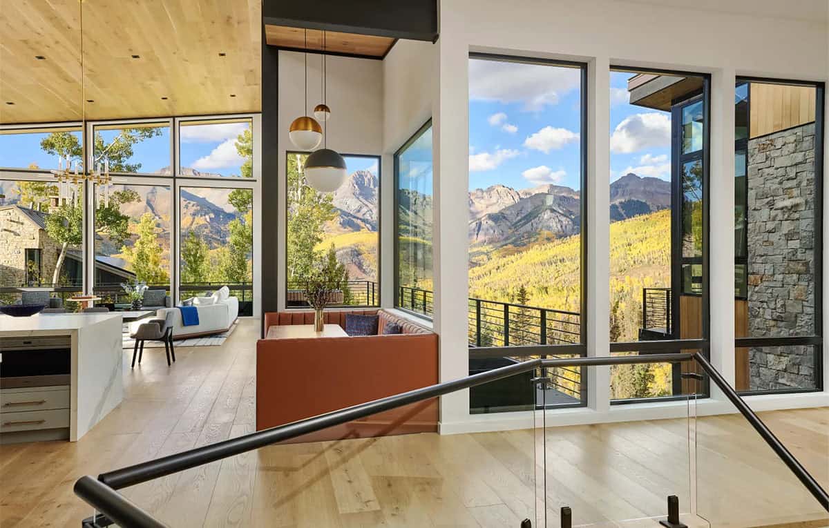 Stairwell landing with banquette seating and layered mountain views