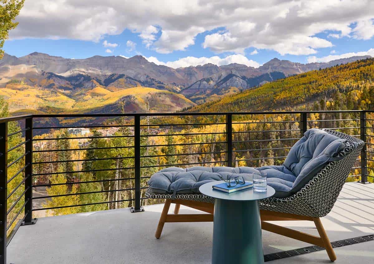 Chaise lounge on a balcony overlooking Telluride's fall foliage