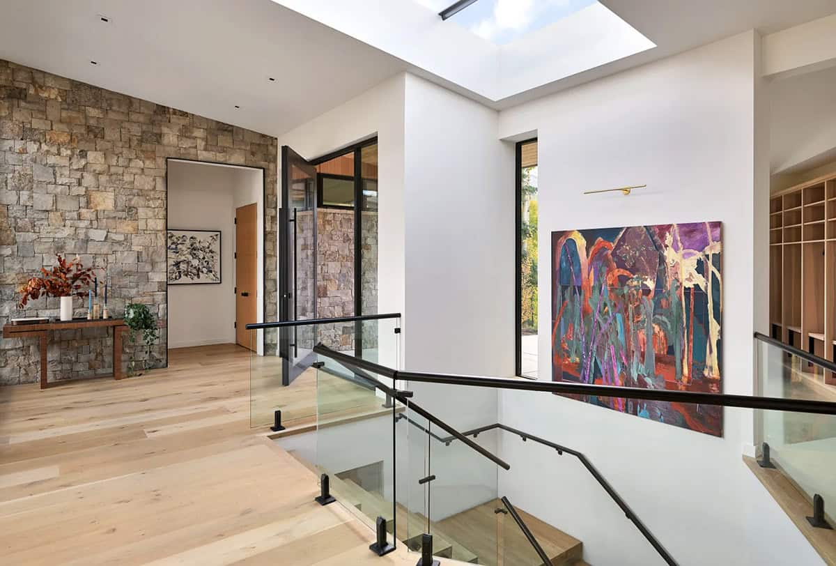 Stairway landing with stone wall and framed artwork display