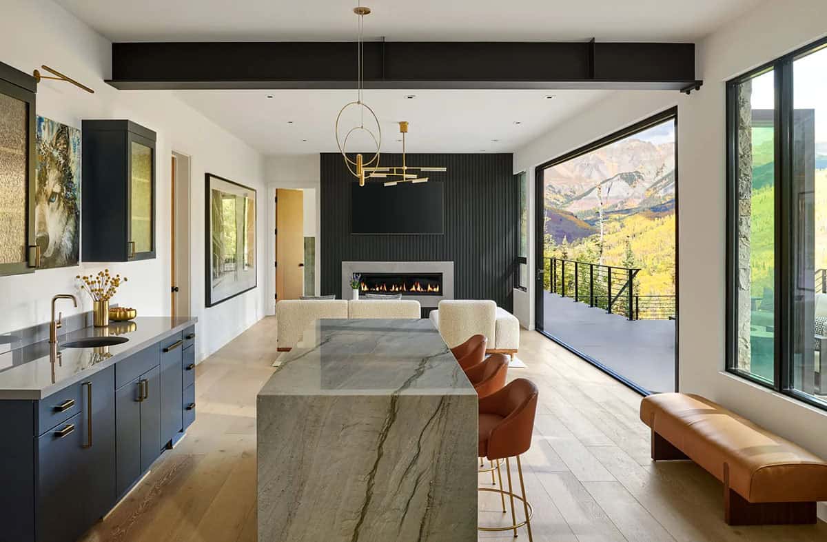 home bar with navy cabinetry and marble waterfall island