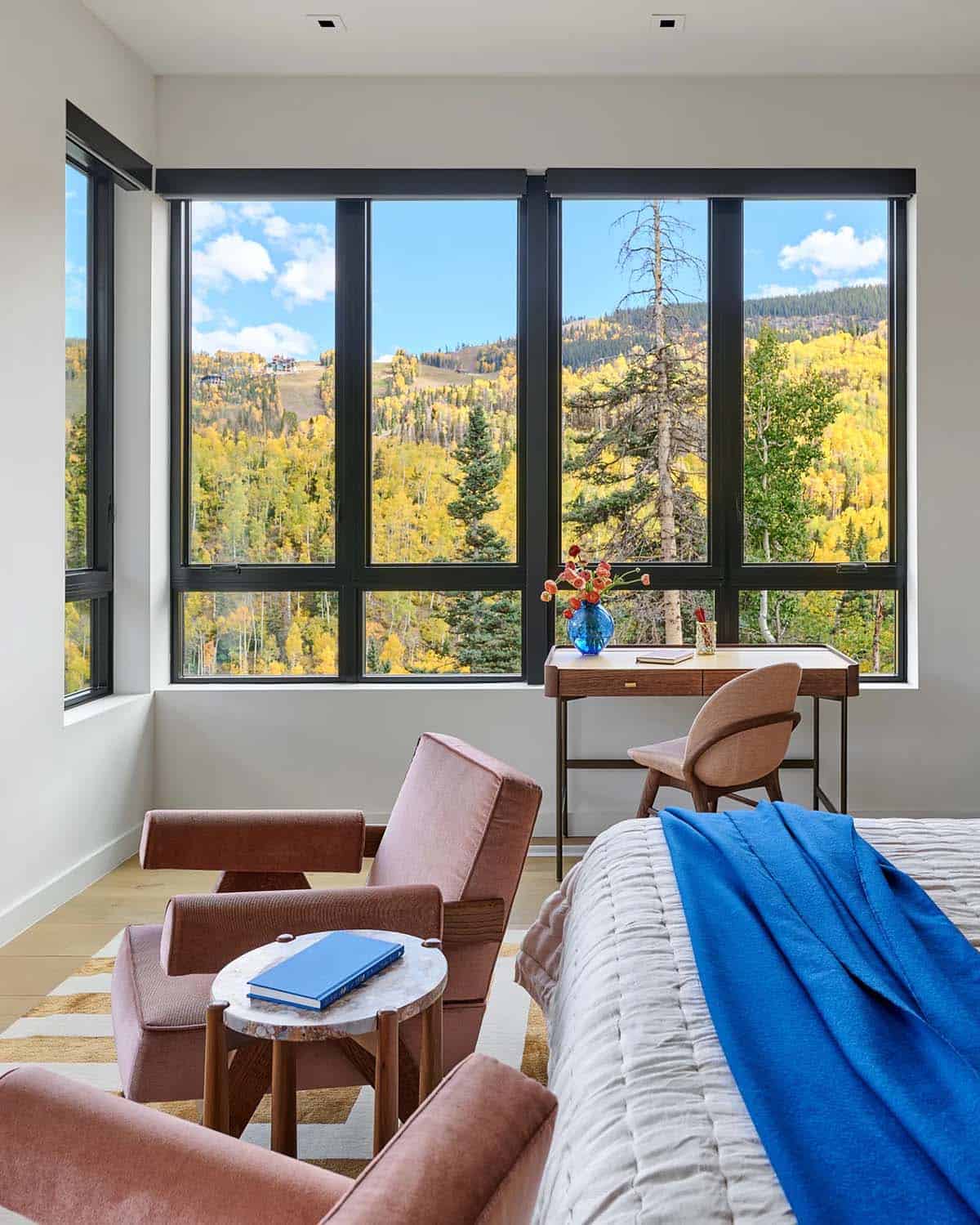 Bedroom seating area with wraparound windows and aspen views