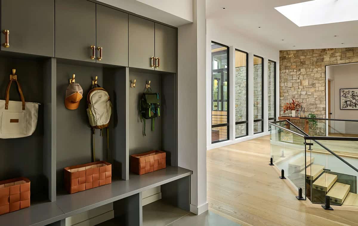 Mudroom with open cubbies and view down a stone hallway