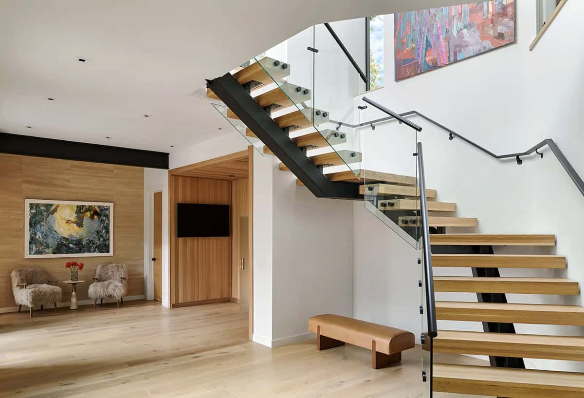 Entry with sheepskin chairs and floating wood tread staircase
