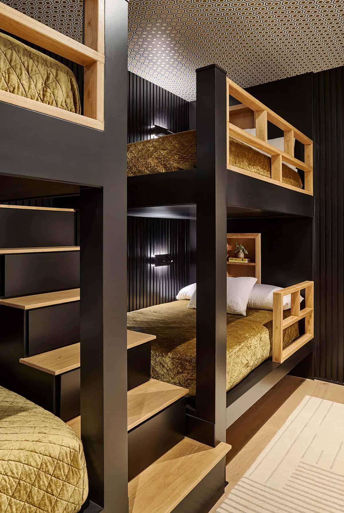 Built in bunk room with black frames and gold velvet bedding