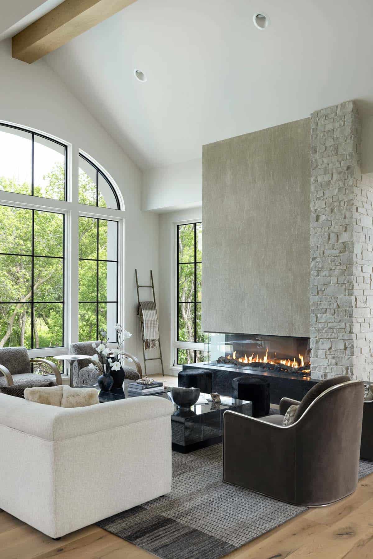 Linear gas fireplace with textured surround, stone column, and cozy seating