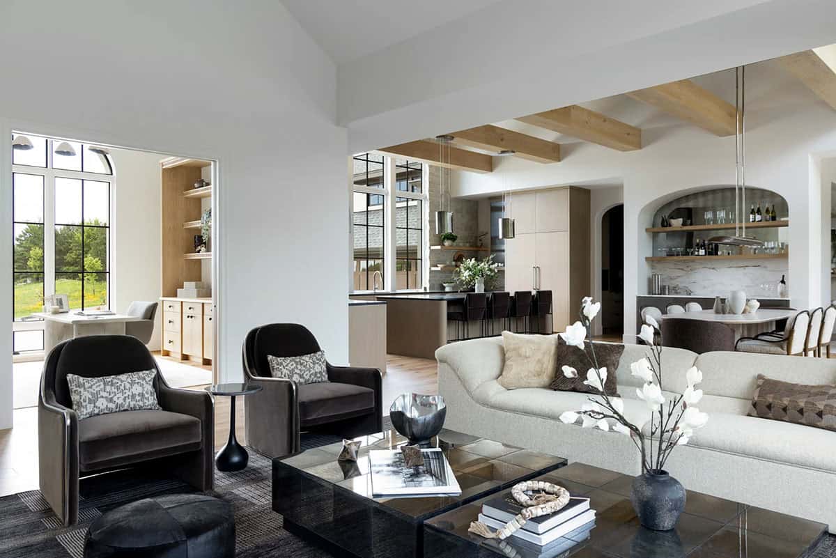 Living room open to kitchen with wood beams and arched wine bar