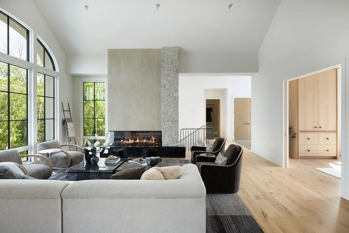 Open living room with fireplace, cream sectional, and light wood floors