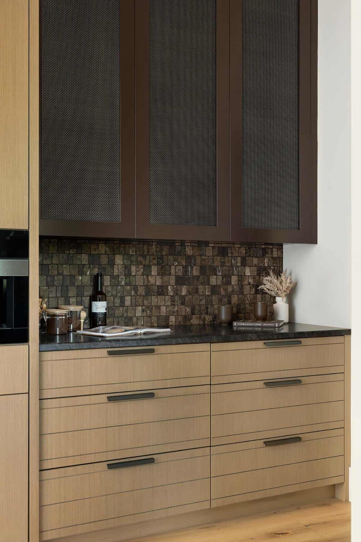 Coffee station with bronze mesh cabinets, mosaic backsplash, and grooved oak drawers