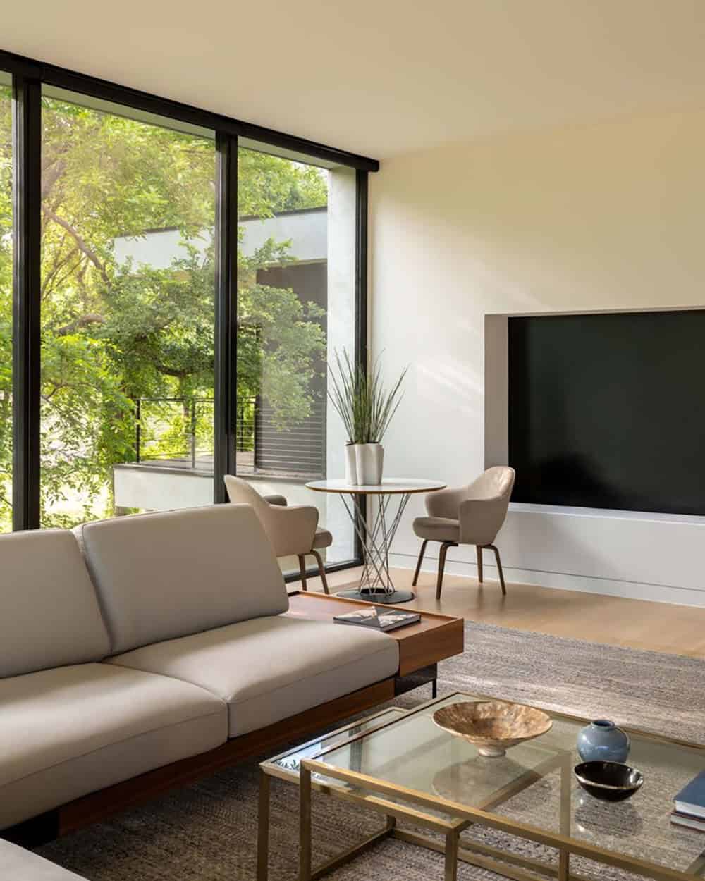 Living room corner with television and glass wall view