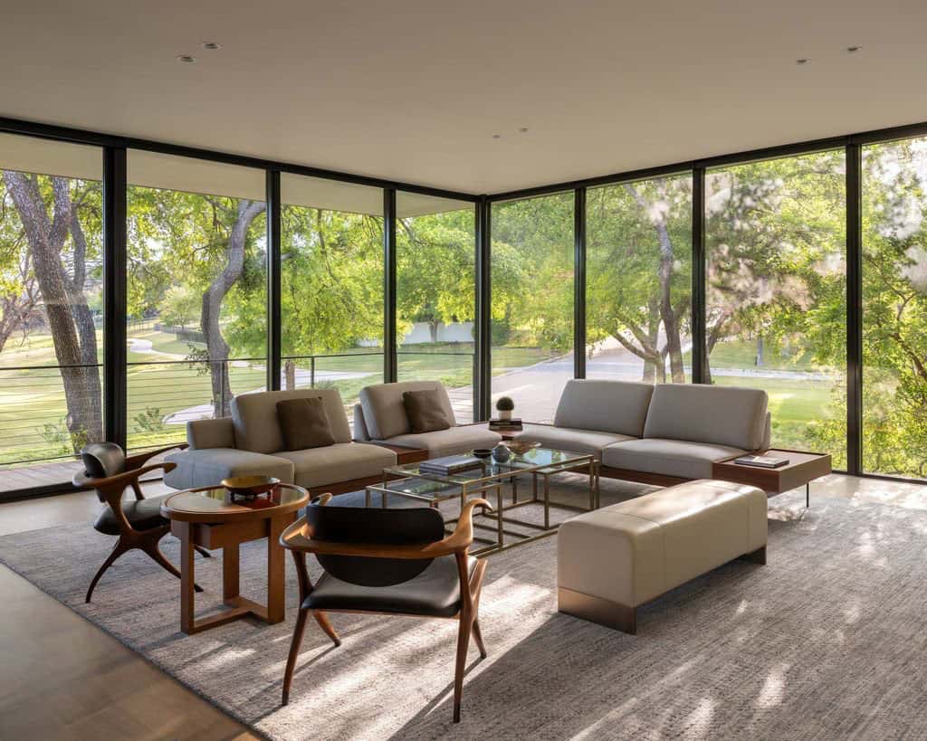 Corner living room with wraparound glass and garden view