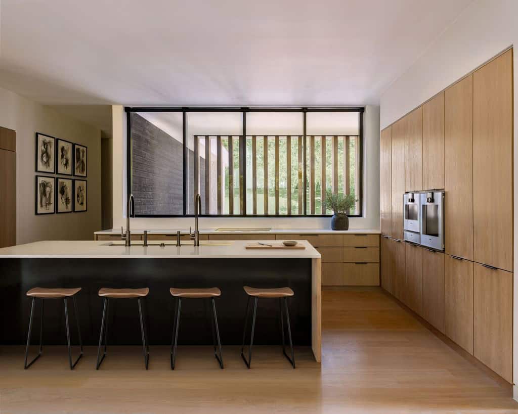 Kitchen island with wood cabinetry and slatted window