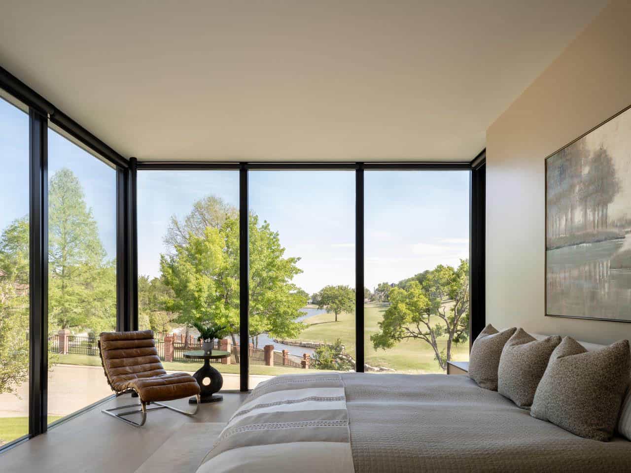 Primary bedroom corner windows overlooking golf course pond