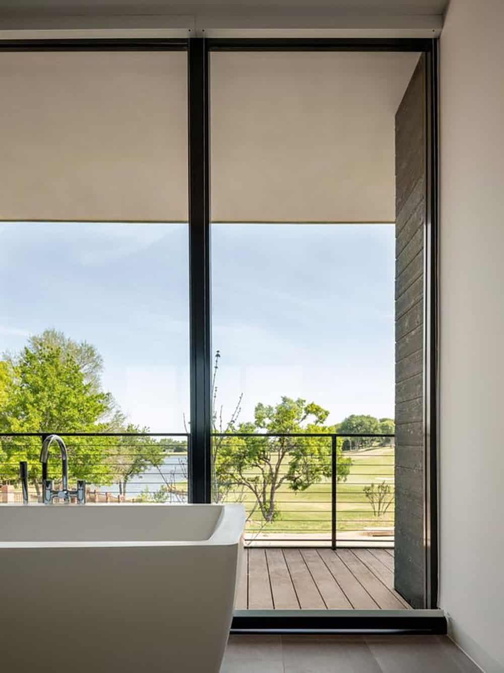 Bathroom soaking tub with glass wall and deck view