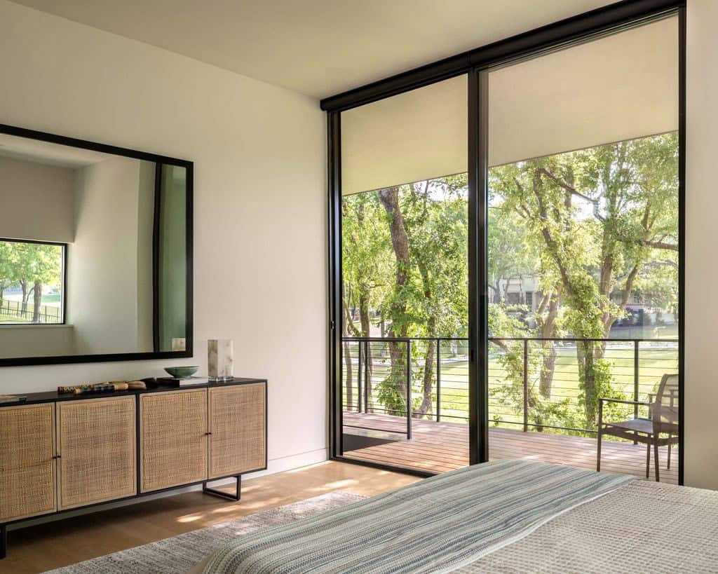 Bedroom with woven cabinet and sliding doors to balcony