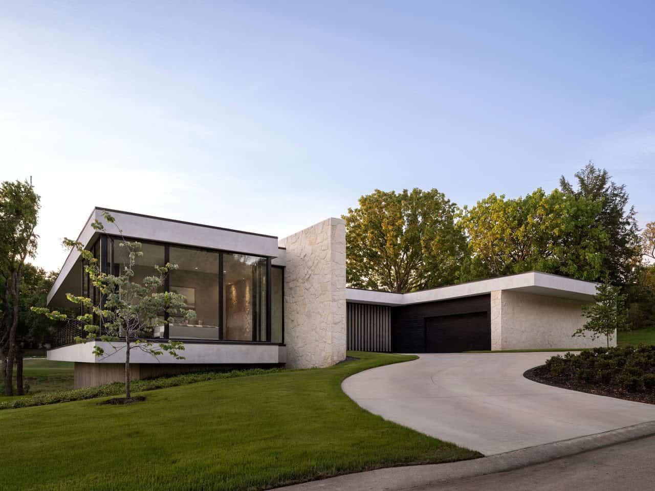 Modern home exterior with curved driveway and stone facade