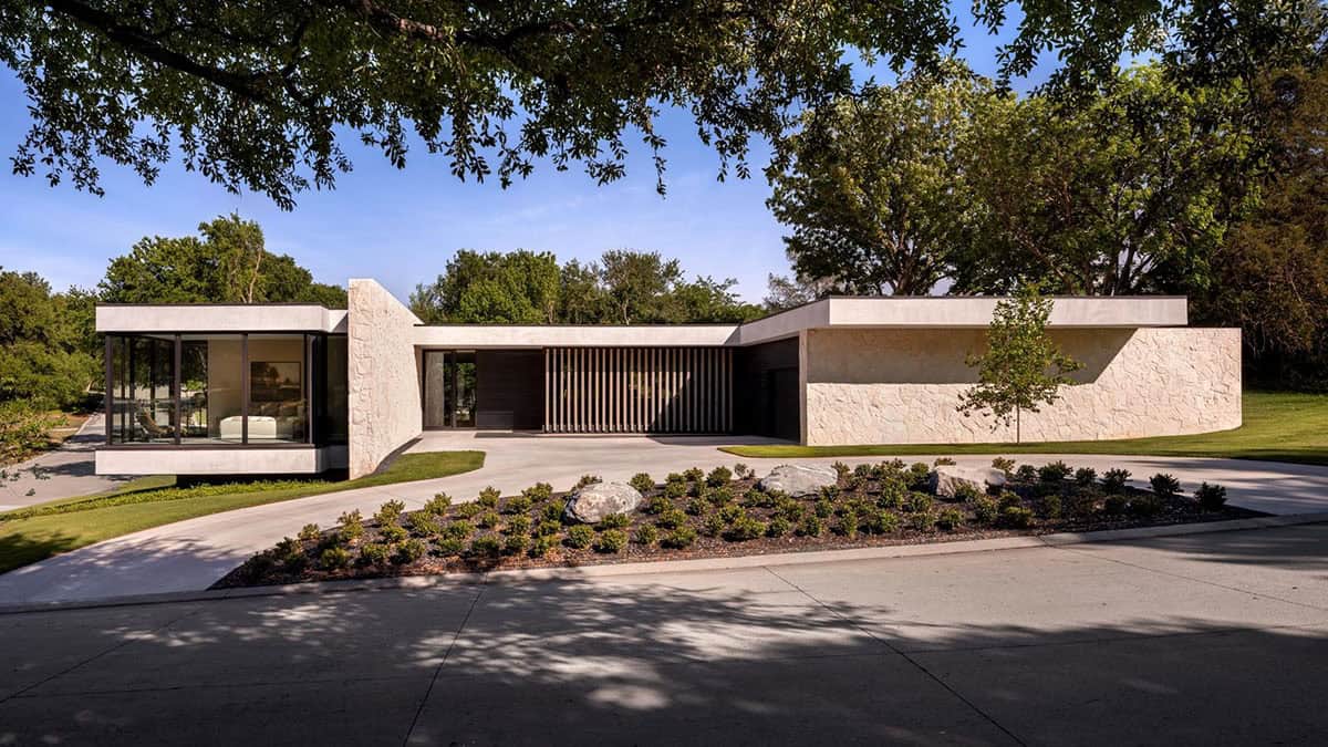 Front exterior of home framed by mature trees