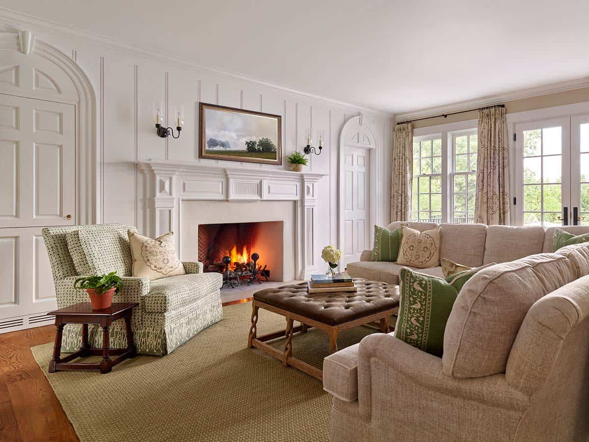 Wood paneled living room with fireplace and neutral sectional seating