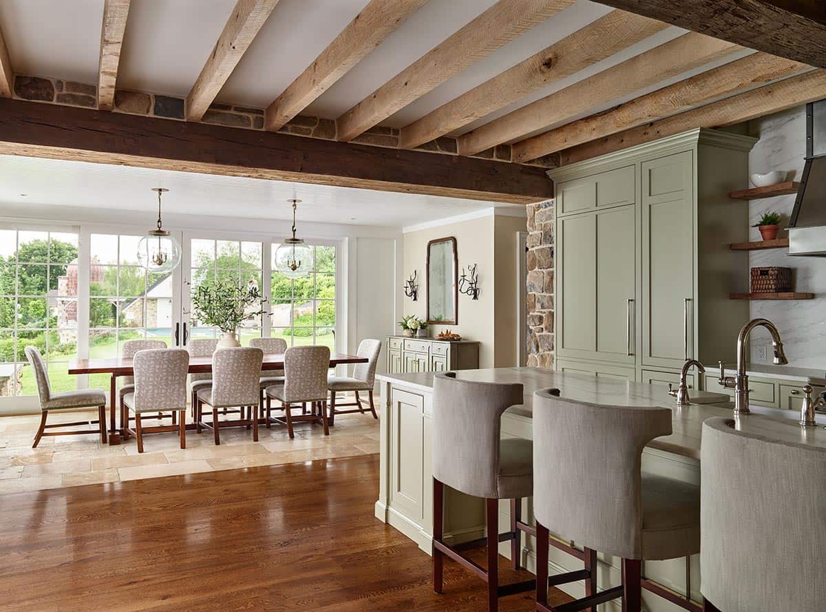 Open kitchen and dining area with exposed beams and pendant lights