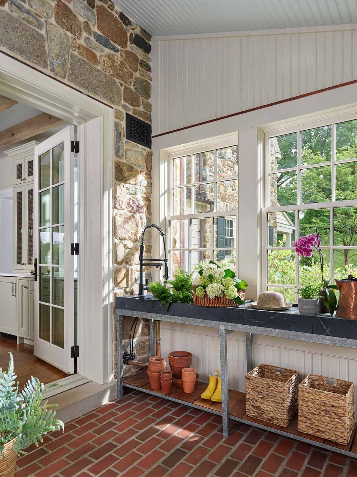 Mudroom potting station with soapstone counter and brick flooring