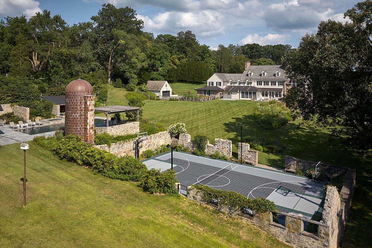 Aerial view of the estate with pool, silo, and sport court