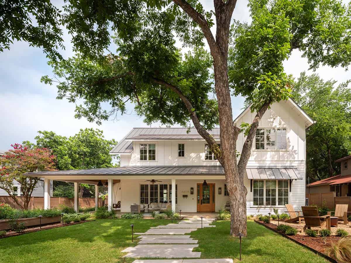 Modern farmhouse exterior with standing seam roof and wraparound porch