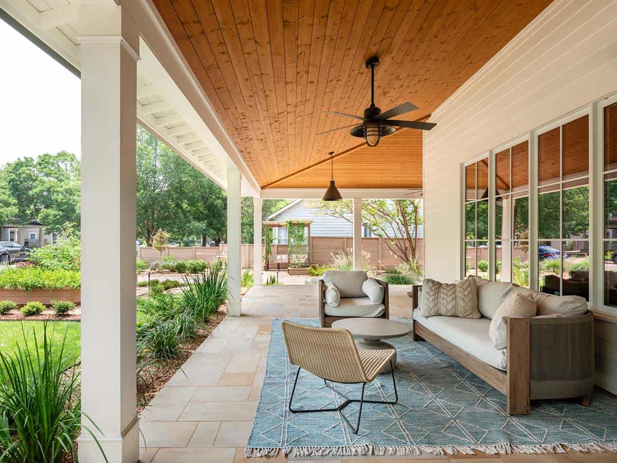 Covered back porch with wood ceiling and outdoor seating area