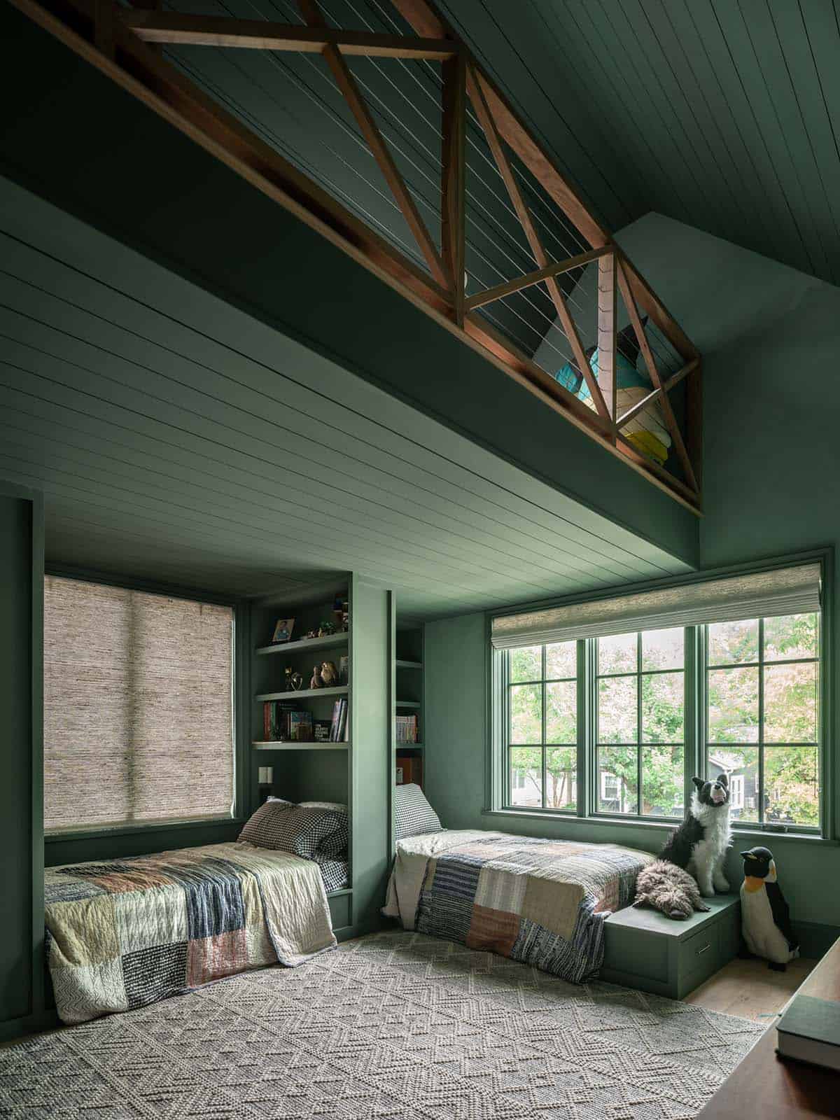 Green painted bunk room with cable railing loft above beds