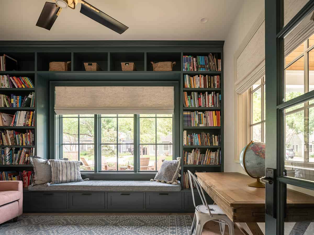Built-in bookshelves flanking window seat in home office nook