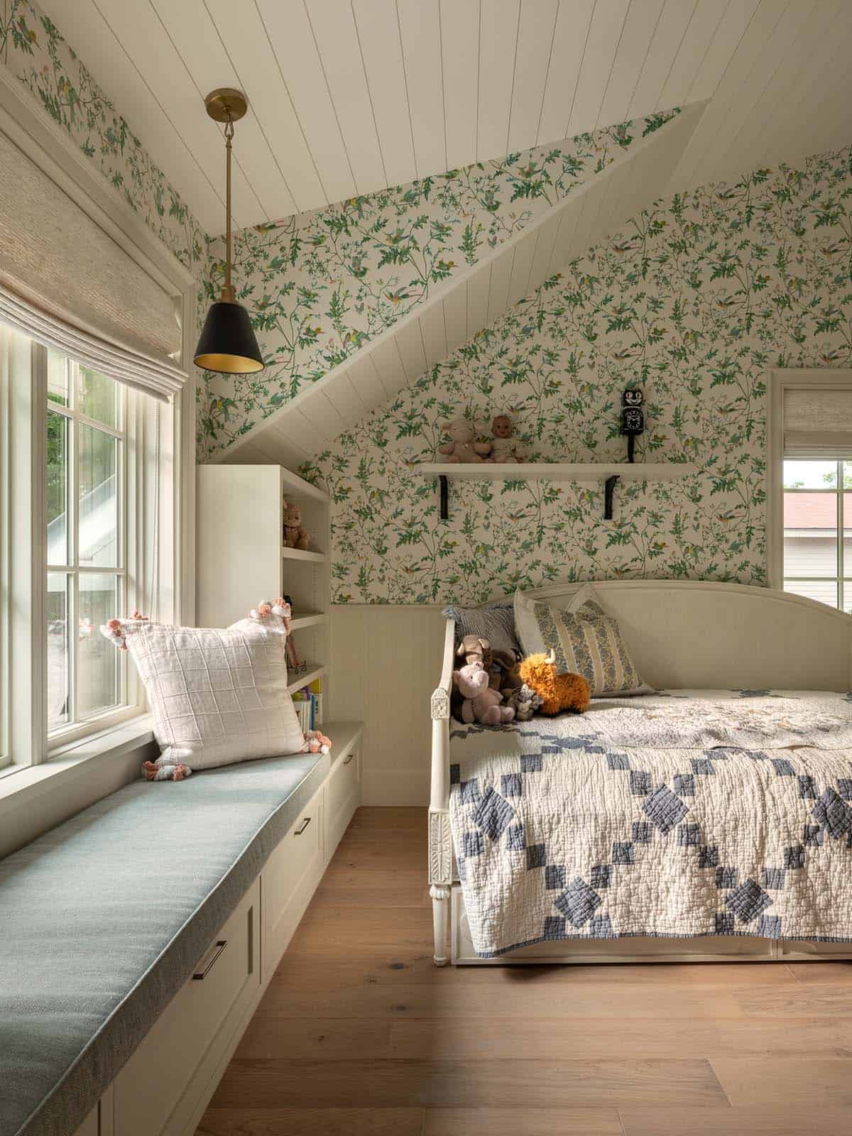 Girl's bedroom with floral wallpaper and daybed under sloped ceiling