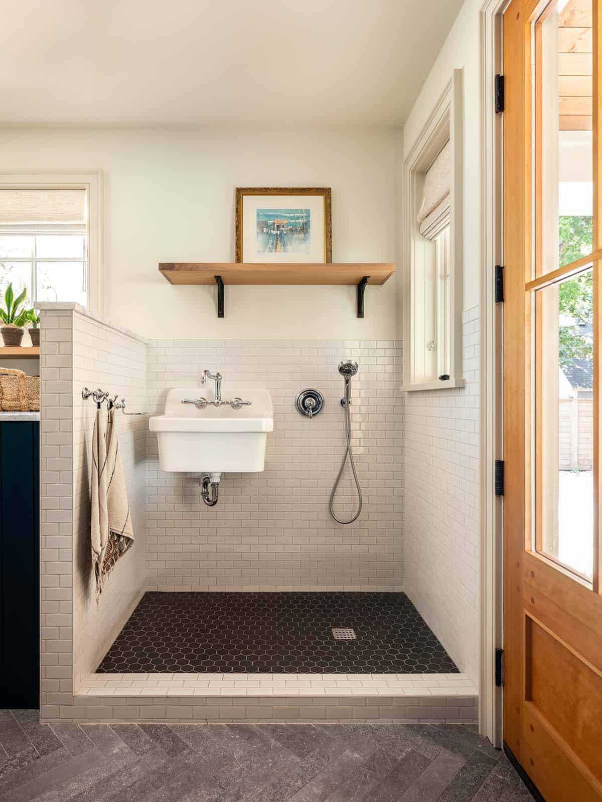 Mudroom dog wash station with subway tile and hex floor