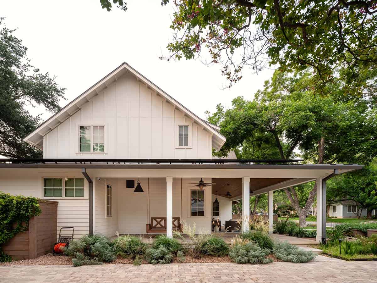 Farmhouse exterior gable end with white siding and covered porch