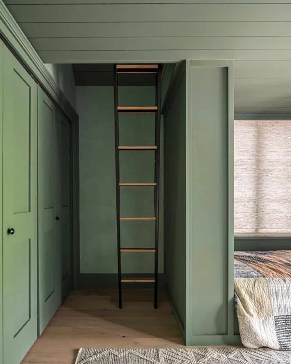 Green bunk room with built-in ladder to sleeping loft