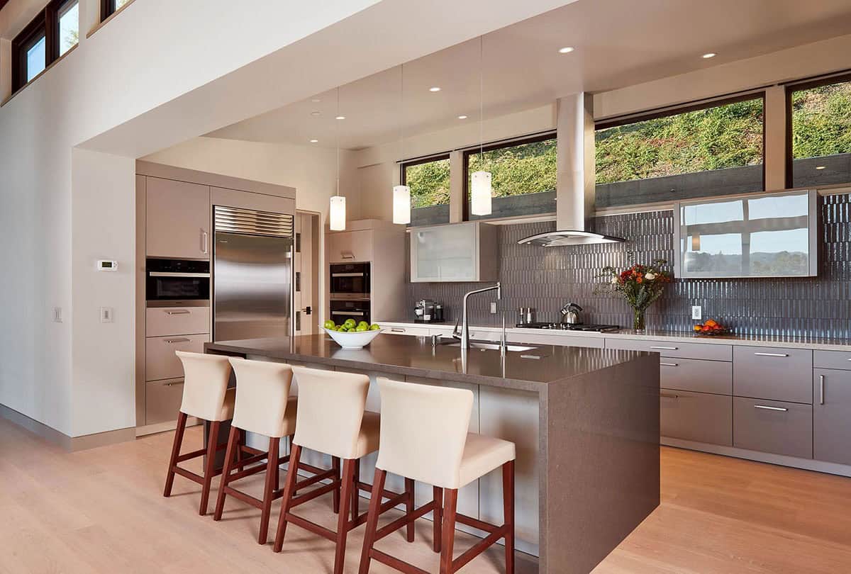 Kitchen island with pendant lighting and mountain views through clerestory windows