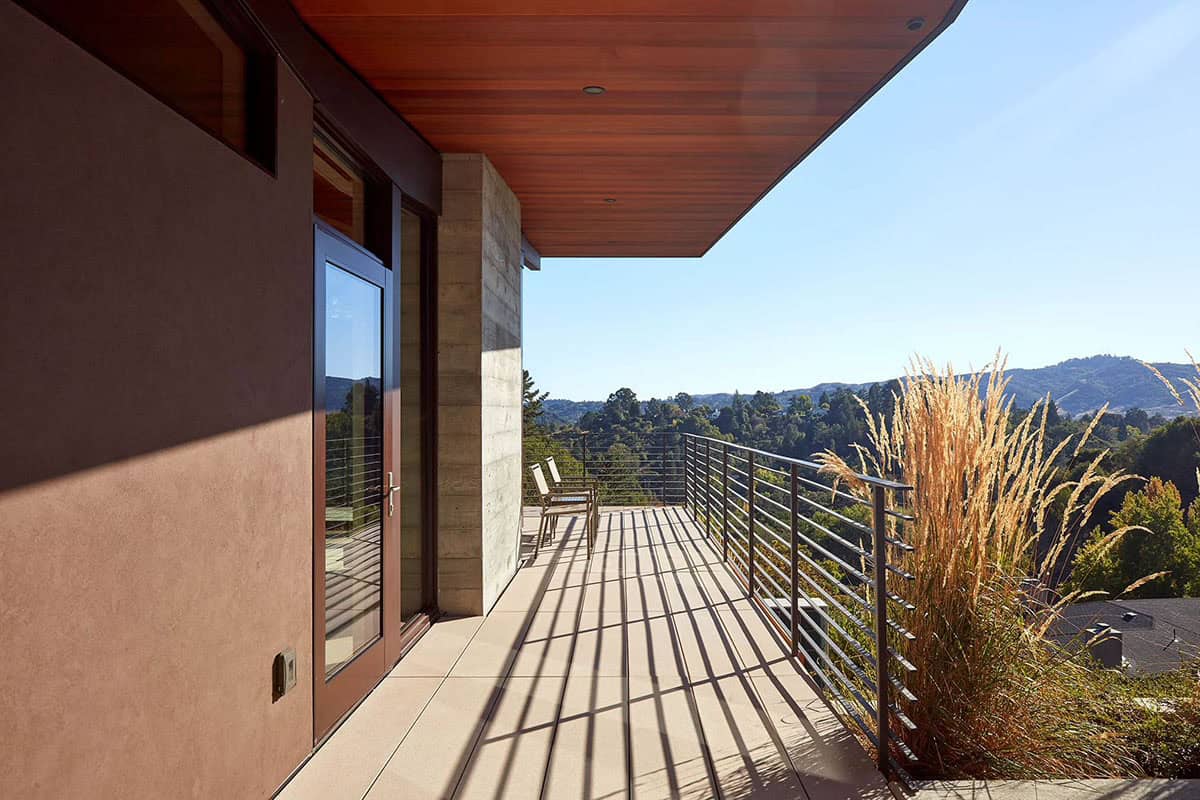 Wraparound deck with cedar ceiling offers sweeping views of wooded hillside