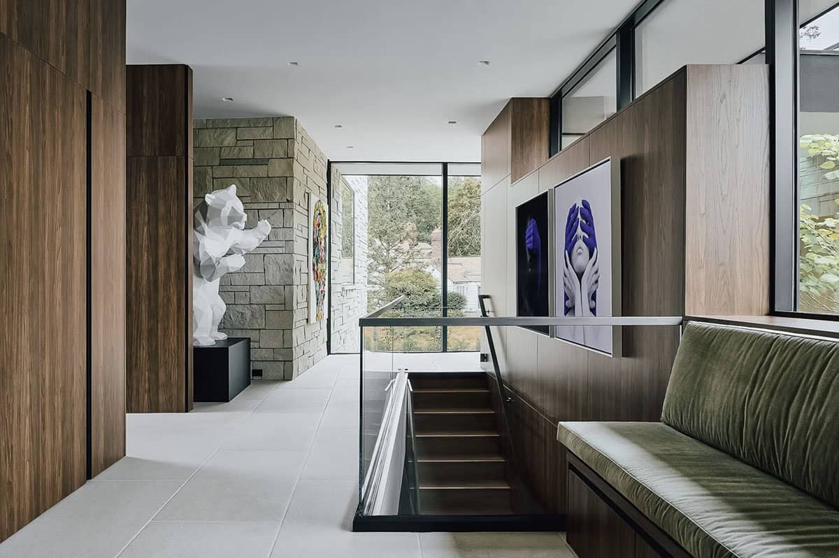 Upper hallway with walnut cabinetry and standing bear sculpture