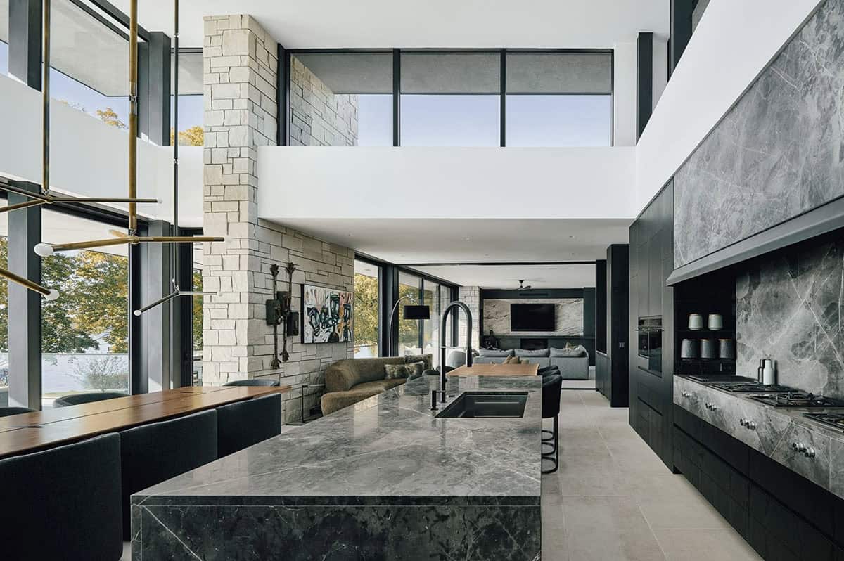Open kitchen with marble island overlooking the two story living room